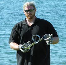 Chris Rider with a hand bent steel sculpture